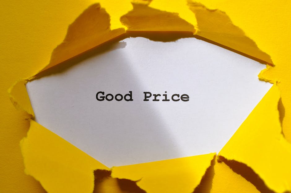 A close-up image shows a piece of bright yellow paper torn open to reveal a white interior with the words 'Good Price' printed in black. The torn edges of the paper are irregular and jagged, creating 